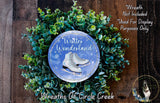 A wreath made of green leaves and a pair of white skis, with the text "Winter Wonderland" and "Wreaths of Circle Creek" displayed on it.