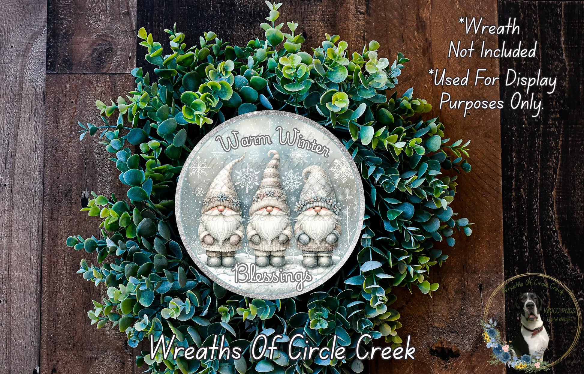 A wreath made of green leaves and topped with three gnome figurines, with a silver plaque in the center that reads "Wreath Not Included * Used For Display Purposes Only. * Wreaths of Circle Creek".