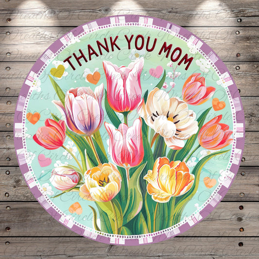 A round floral design with a message "THANK YOU MOM" written on it, surrounded by a border of colorful tulips and other flowers.