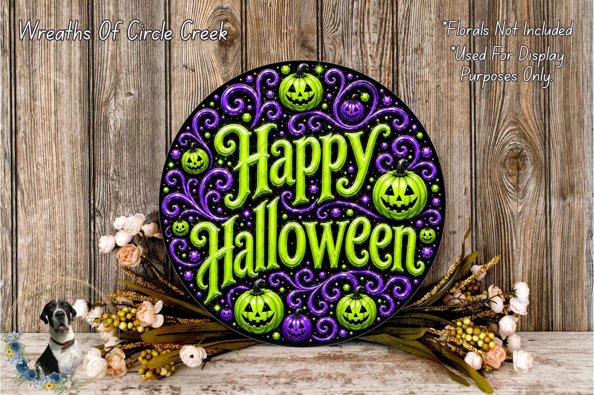 a Halloween-themed sign with a purple and green color scheme, surrounded by a floral arrangement and pumpkins.