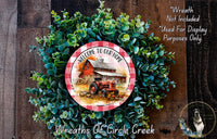 a wreath with a red barn and tractor as the central design, surrounded by green foliage. The wreath is displayed on a wooden surface, and there is a text overlay that reads "Welcome to our home" and "Wreaths of Circle Creek".