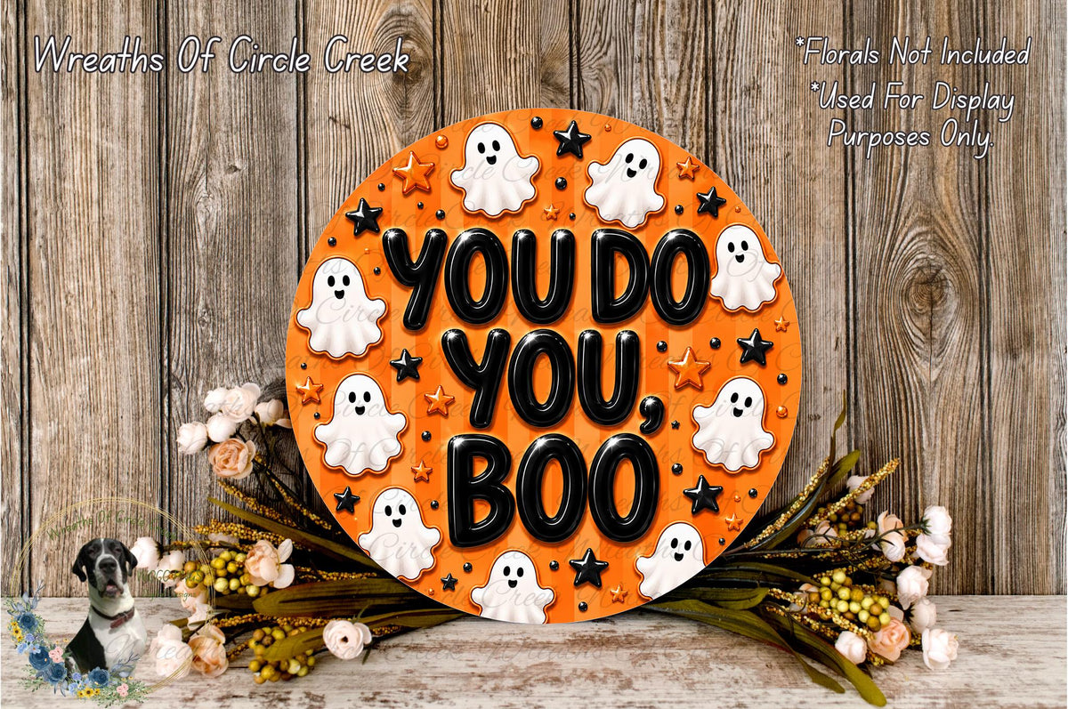 a Halloween-themed sign with the text "YOU DO YOU BOO" surrounded by ghost decorations and flowers.