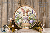 A round wooden plaque with a cartoon rabbit sitting in a floral arrangement, surrounded by Easter eggs and flowers. The plaque has a welcoming message and is displayed against a wooden background.