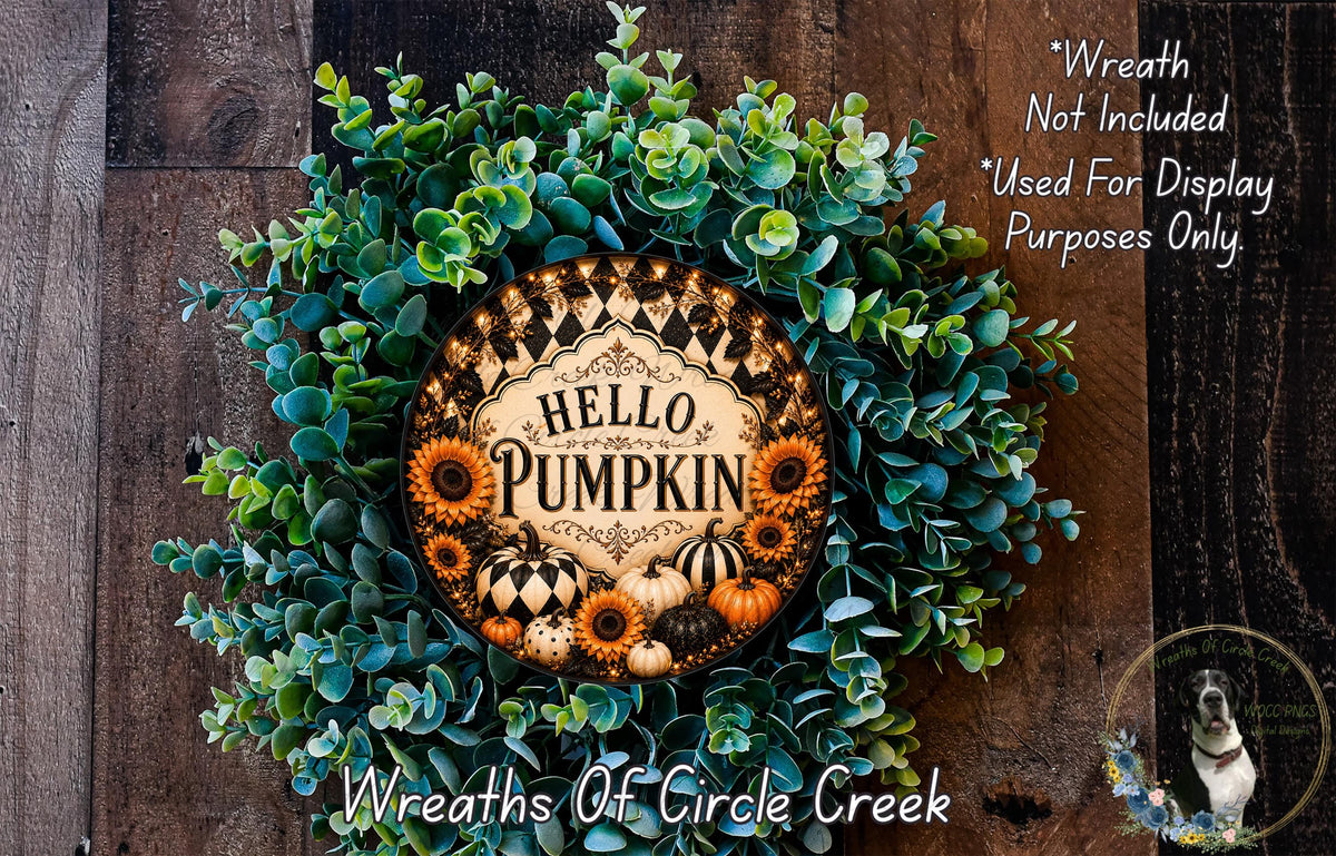 A wreath made of various fall-themed elements, including pumpkins, sunflowers, and greenery, with the text "Hello Pumpkin" displayed on it.