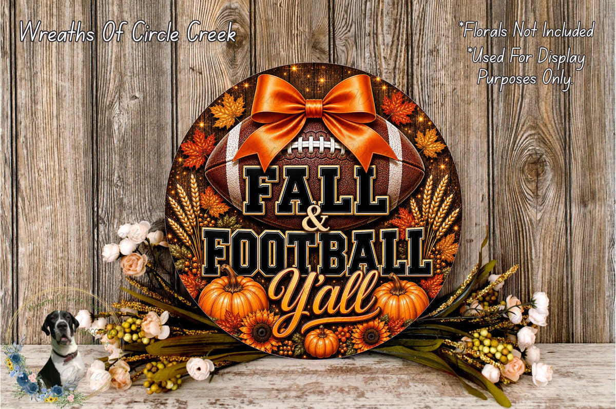 A decorative wreath with the text "FALL & FOOTBALL YALL" and various fall-themed elements such as pumpkins, leaves, and a football. The wreath is displayed on a wooden surface, surrounded by flowers.