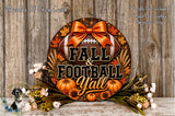 A decorative wreath with the text "FALL & FOOTBALL YALL" and various fall-themed elements such as pumpkins, leaves, and a football. The wreath is displayed on a wooden surface, surrounded by flowers.