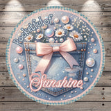 A round, decorative image featuring a denim pocket with a pink bow, surrounded by various decorative elements such as flowers, pearls, and bubbles. The text "Pocketful of Sunshine" is prominently displayed, suggesting a cheerful and uplifting theme.