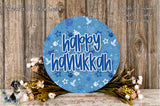 A circular sign with the text "happy Hanukkah" in blue and white, surrounded by a floral arrangement and a wooden background.