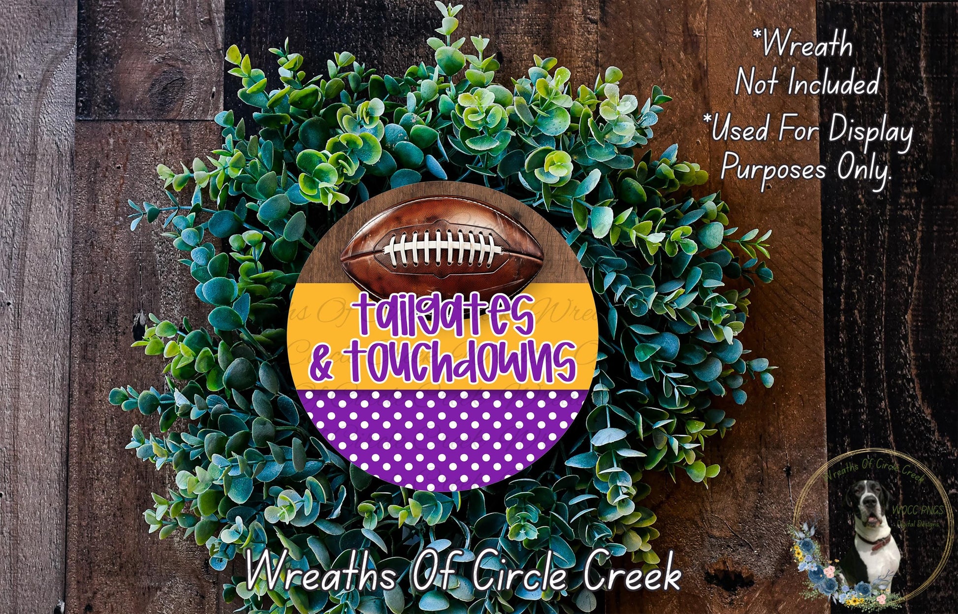 a wreath made of green foliage and a football, with the text "Tailgates & Touchdowns" written on it. The wreath is displayed on a wooden surface, and there is a small dog in the bottom right corner of the image.