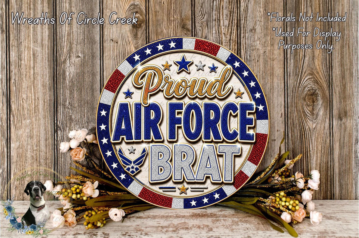 a patriotic wreath with the text "Proud Air Force Brat" displayed prominently. The wreath is surrounded by flowers, and the background is a wooden wall.