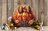 A decorative wreath with a leopard print bow, a pumpkin, and fall-themed flowers, placed on a wooden surface.