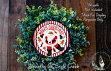 A Christmas wreath made of green foliage and a Santa Claus design, with the text "Merry Christmas" and "Wreath Not Included" indicating that the wreath is not included in the display.