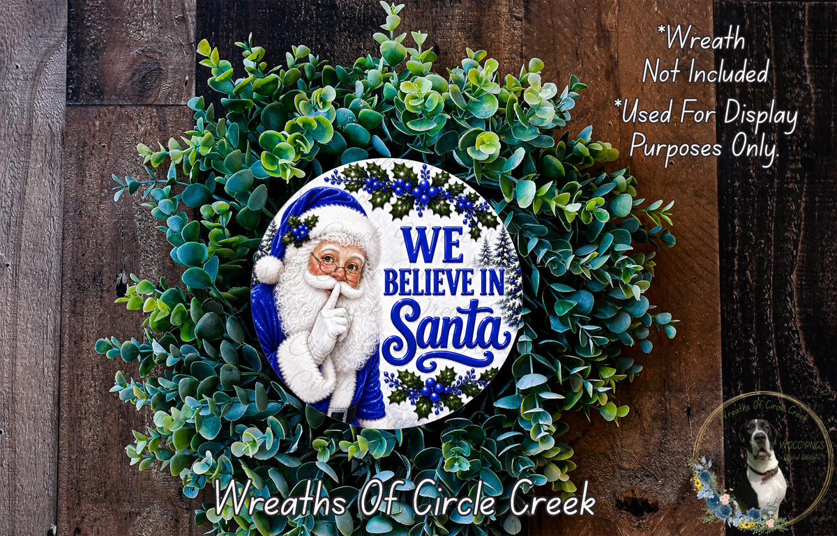 A wreath made of green leaves and a Santa Claus figurine, with the text "We Believe in Santa" displayed on it.