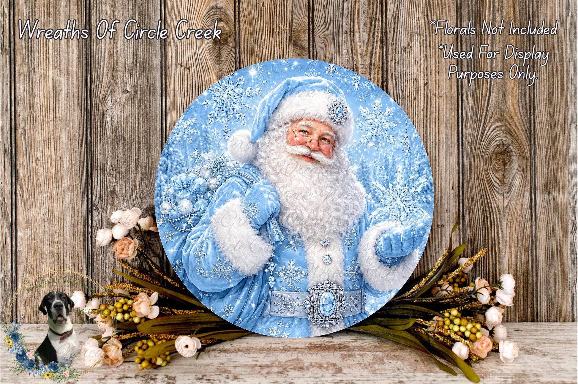 A round, blue-colored wreath depicting Santa Claus holding a bag of presents, surrounded by a floral arrangement and a wooden background.