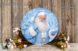 A round, blue-colored wreath depicting Santa Claus holding a bag of presents, surrounded by a floral arrangement and a wooden background.