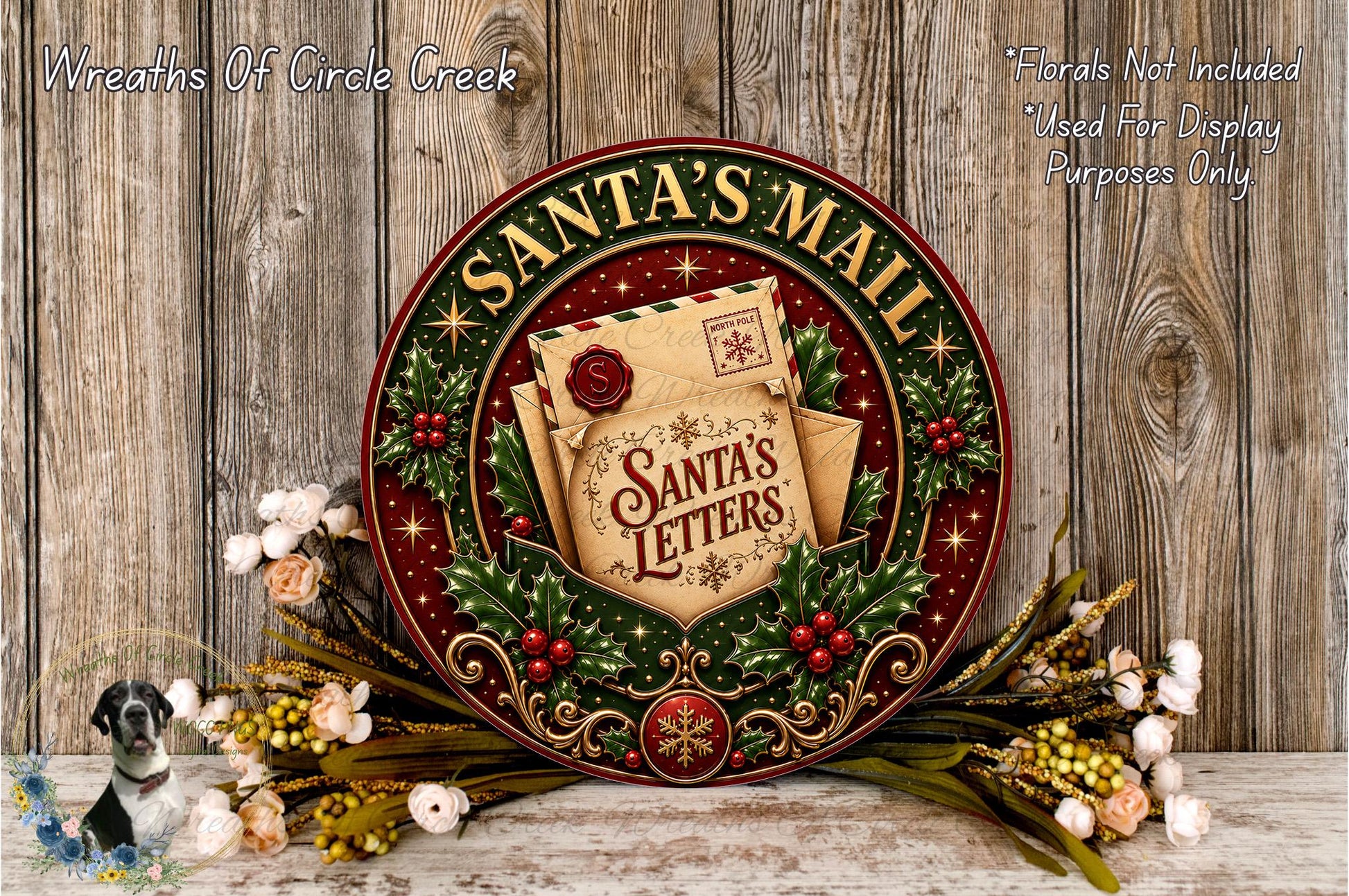 A decorative Santa's Mail wreath with a letter and a small Santa's letter, surrounded by flowers and greenery, against a wooden background.