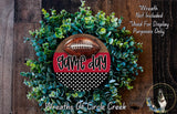 a wreath made of green foliage and a football, with the word "game day" written on it. The wreath is displayed on a wooden surface, and there is a text overlay that reads "Wreath Not Included * Used For Display Purposes Only".