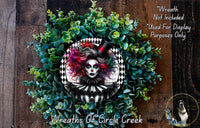 a wreath with a woman's face in the center, surrounded by green foliage. The wreath is described as a "Wreath of Circle Creek" and is not included in a display.