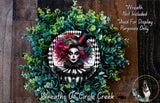 a wreath with a woman's face in the center, surrounded by green foliage. The wreath is described as a "Wreath of Circle Creek" and is not included in a display.