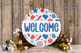 a circular welcome sign with patriotic designs, surrounded by flowers and a wooden background.