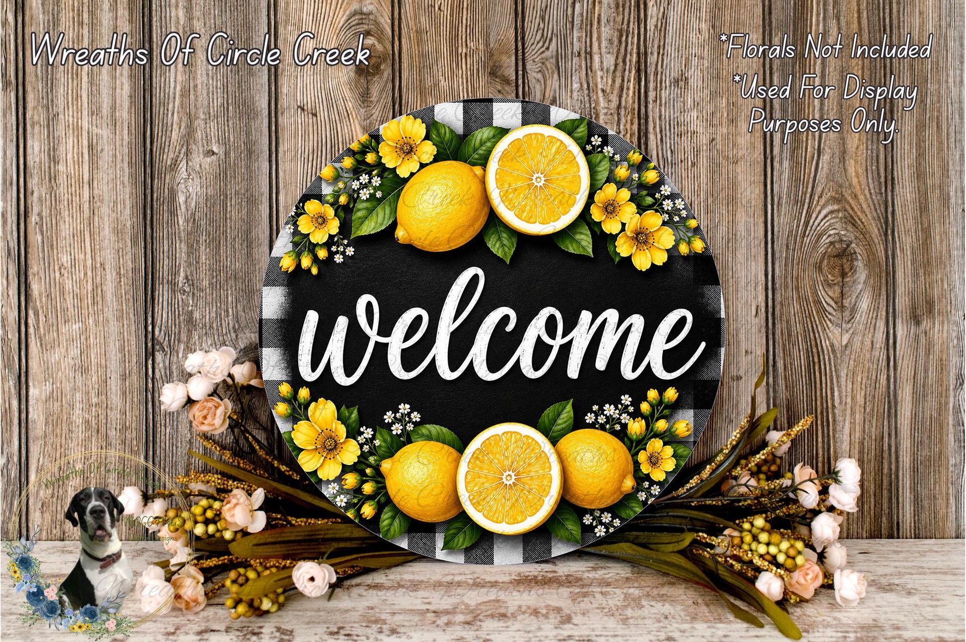 A decorative welcome sign with a black and white checkered border, surrounded by yellow flowers and orange slices. The sign has the word "welcome" written on it.