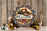 a wooden sign with a cowboy hat and the word "WELCOME" written on it, surrounded by a colorful wreath and flowers.