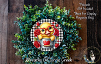 A wreath made of green leaves and red roses, with a yellow duck wearing red glasses and a red heart-shaped bucket.