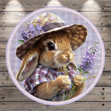 A cute rabbit wearing a hat and holding flowers in its paws, set against a wooden background.