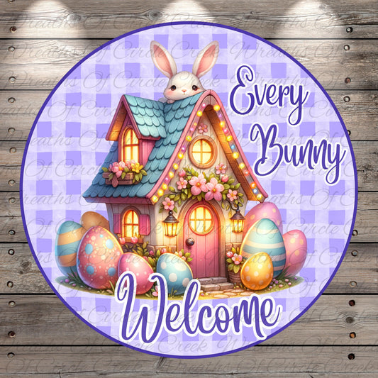 A whimsical illustration of a colorful Easter house with a bunny peeking out from the roof, surrounded by decorated Easter eggs. The text "Every Bunny Welcome" is displayed in the image.