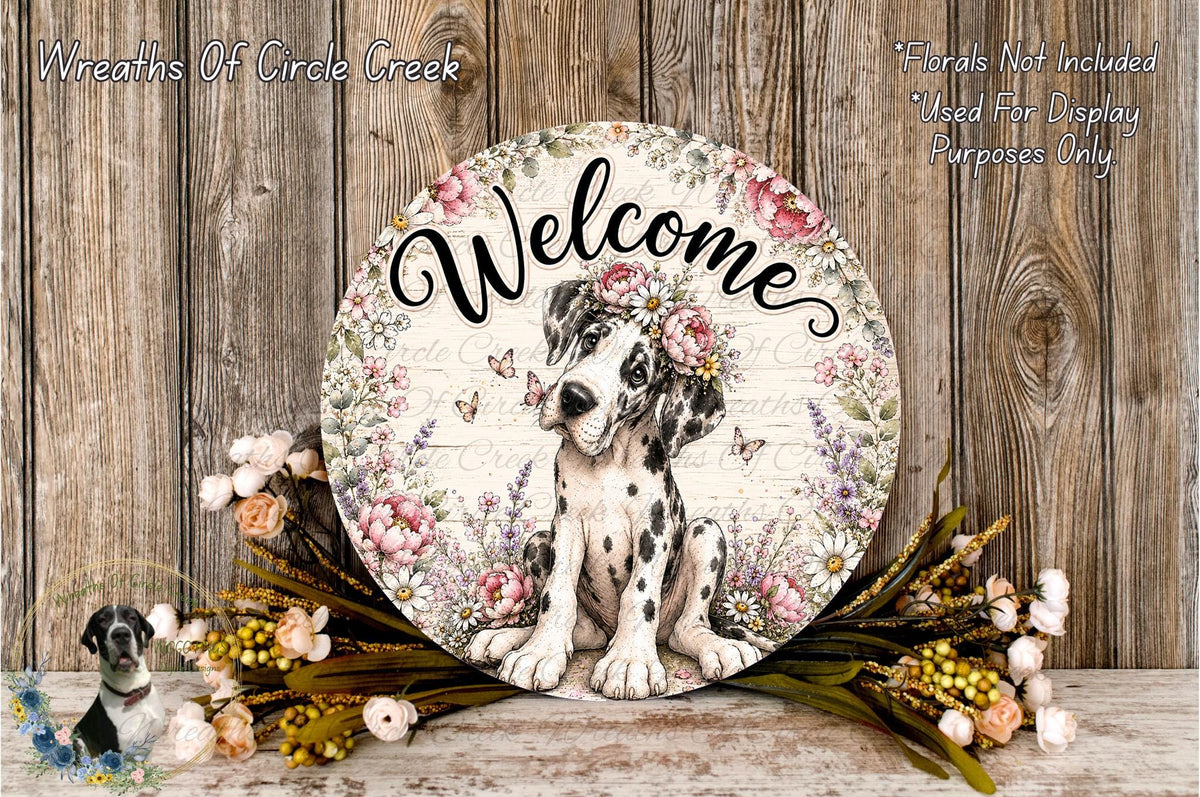 A decorative sign featuring a black and white spotted dog surrounded by flowers and greenery, with the word "Welcome" written on it.
