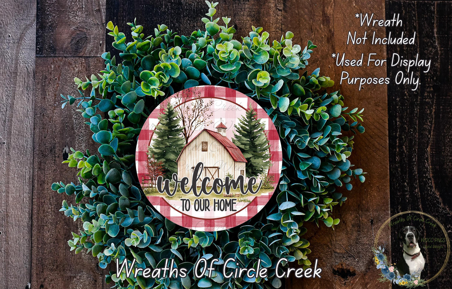 a wreath with a house and trees, surrounded by greenery, and a sign that reads "Welcome to Our Home".