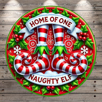 A festive circular design with a red and white striped ribbon, a pair of red and white striped boots, and the text &quot;HOME OF ONE&quot; and &quot;NAUGHTY ELF&quot; against a background of holly leaves and berries.