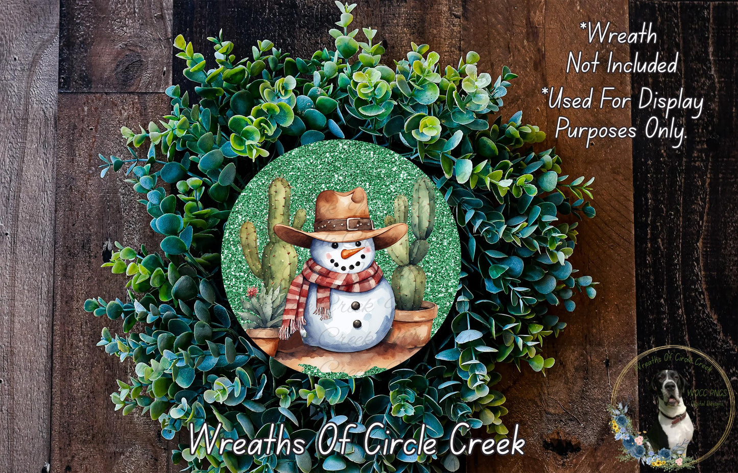 A wreath featuring a snowman wearing a cowboy hat and scarf, surrounded by green succulent plants.