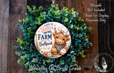 a wreath with a cow wearing a baseball cap and holding a baseball, surrounded by green foliage. The wreath is displayed on a wooden surface, and there is a text overlay that reads "Life is Better on the Farm at the Ballpark Wreaths of Circle Creek".