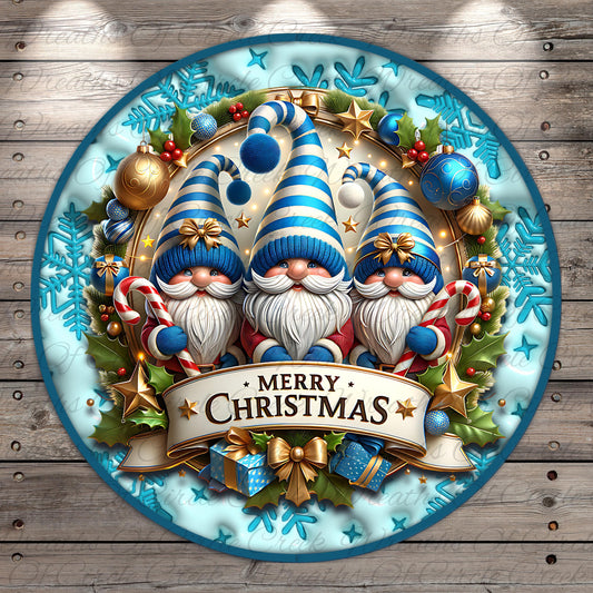 A festive Christmas wreath with three gnomes wearing blue and white striped hats, surrounded by various holiday decorations such as ornaments, stars, and holly leaves. The wreath is set against a blue background with a white border, and a banner at the bottom displays the text "Merry Christmas".