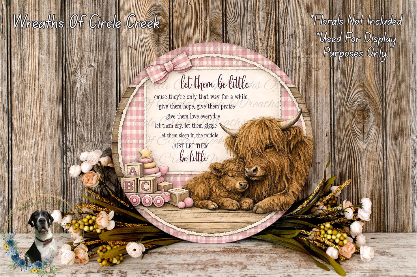 a decorative wreath with a mother and baby illustration, surrounded by flowers and a wooden background.