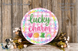 a round sign with the text "lucky charm" written on it, surrounded by a wreath of flowers and a rainbow-colored border.