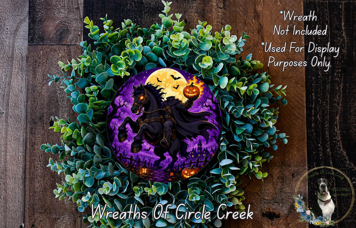 A Halloween-themed wreath made of green foliage and featuring a purple and yellow design depicting a black horse with a jack-o-lantern on its head, surrounded by a full moon and bats.