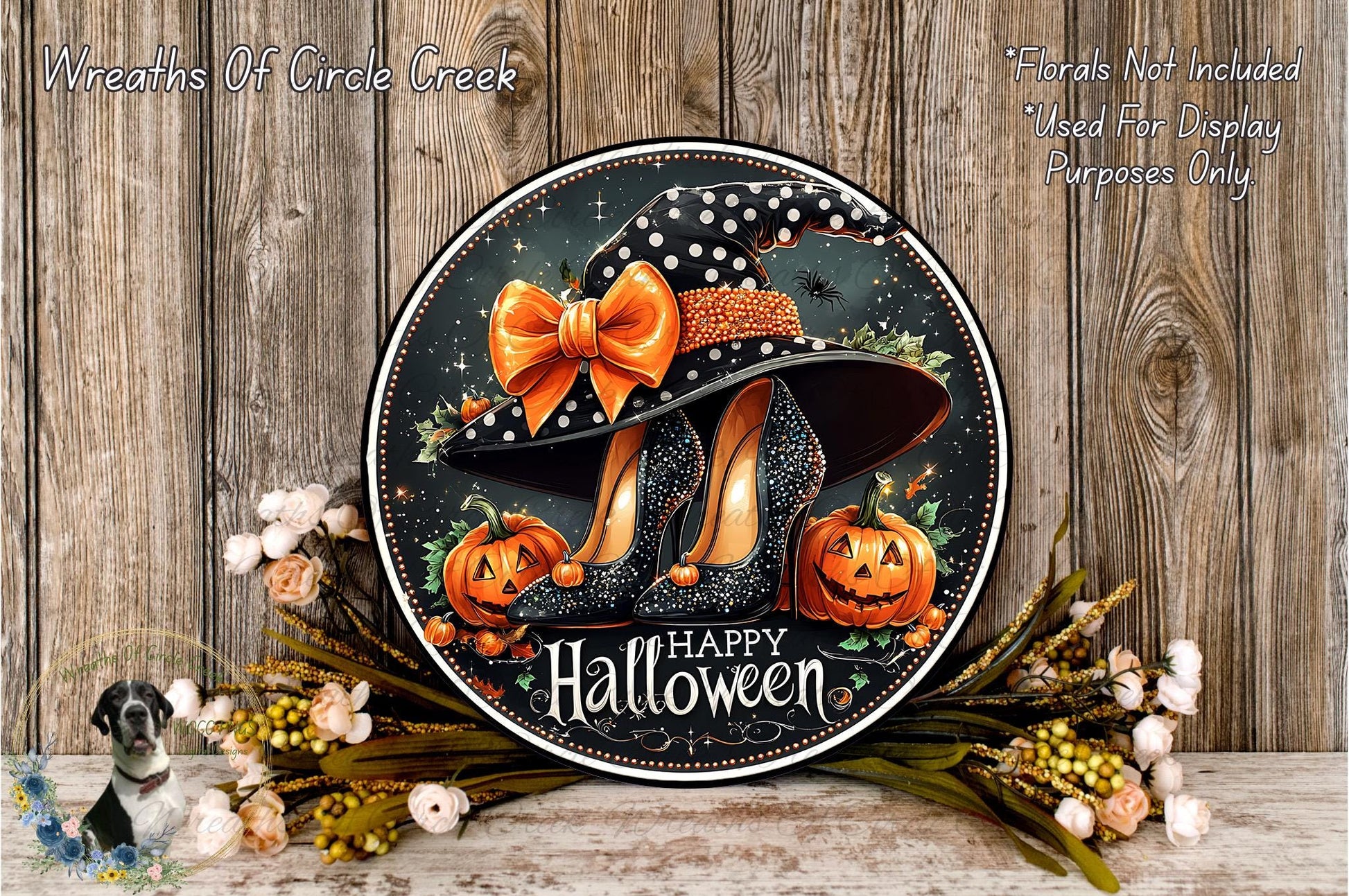A Halloween-themed wreath with a witch's hat, pumpkins, and flowers, along with the text "Happy Halloween" displayed on a wooden background.