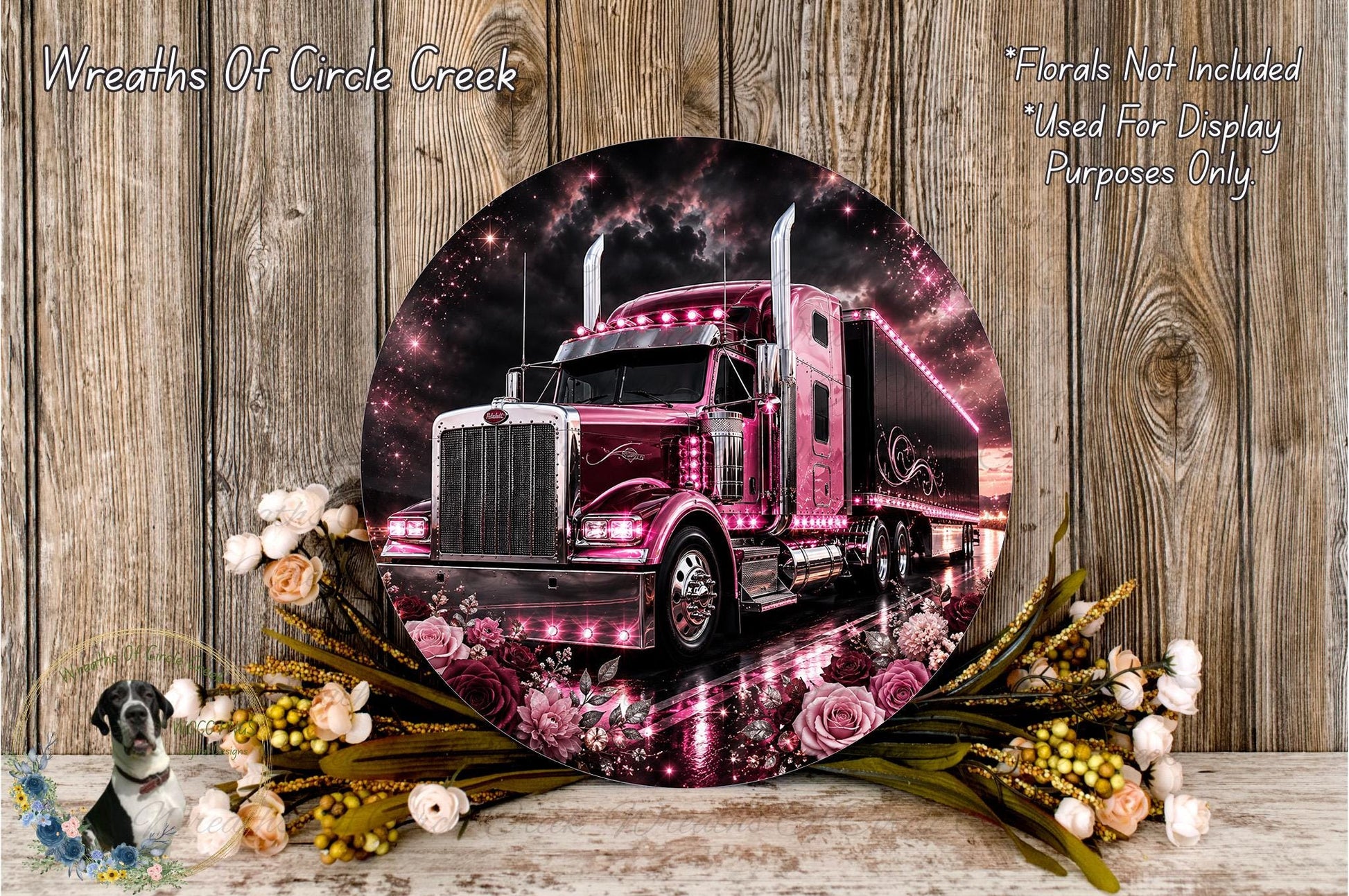 A large, round, metallic print of a pink and black semi-truck surrounded by a floral arrangement of pink and white flowers.
