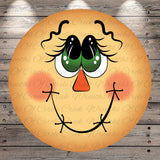 A cheerful, cartoon-like face with large eyes, a red nose, and a big smile, set against a wooden background.