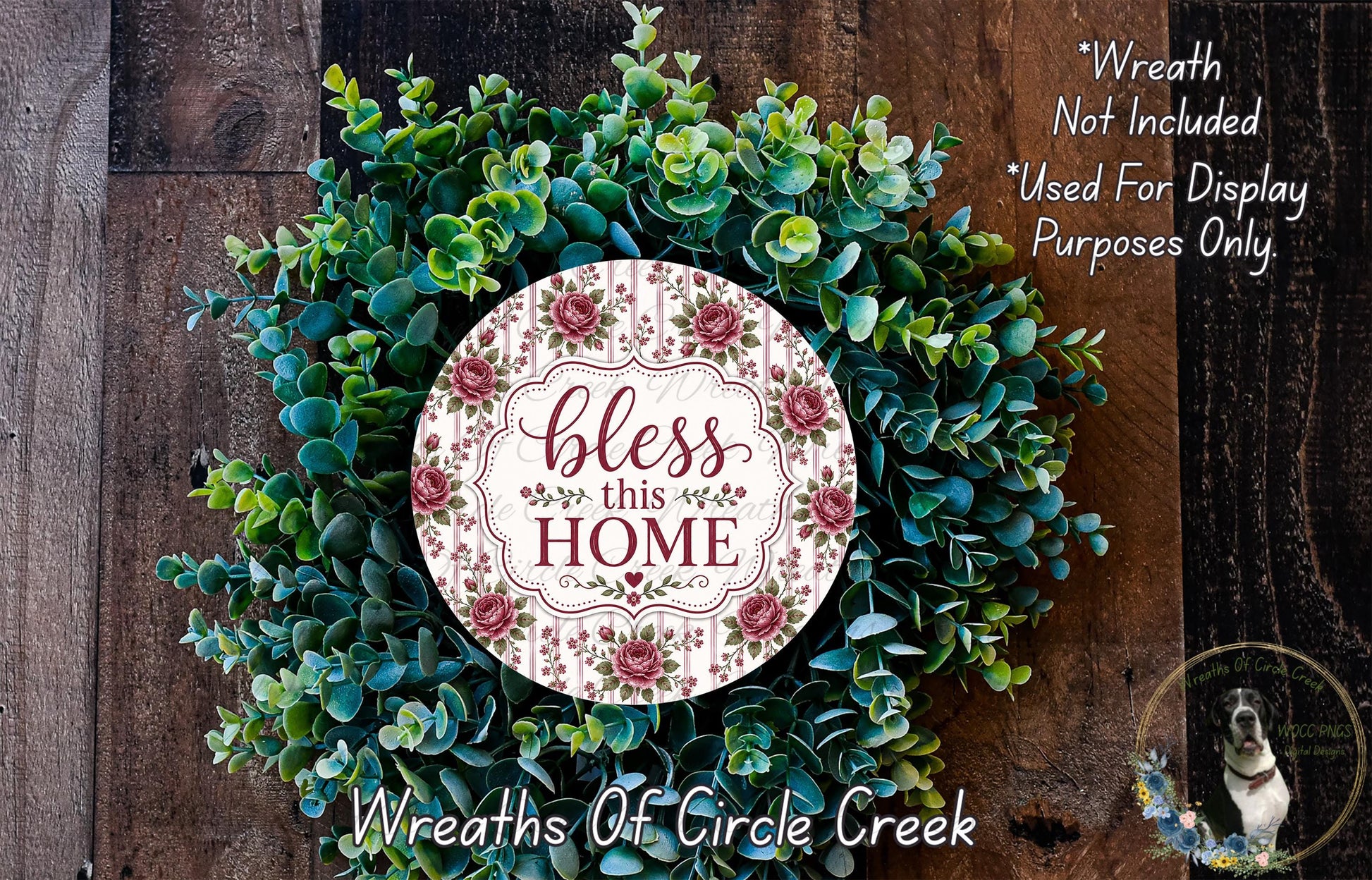 A wreath made of various green and brown foliage, with a circular sign in the center that reads "bless this home".