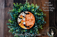 a Halloween-themed wreath made of green foliage and candy canes, with the text "Trick or Treat" displayed on the wreath.