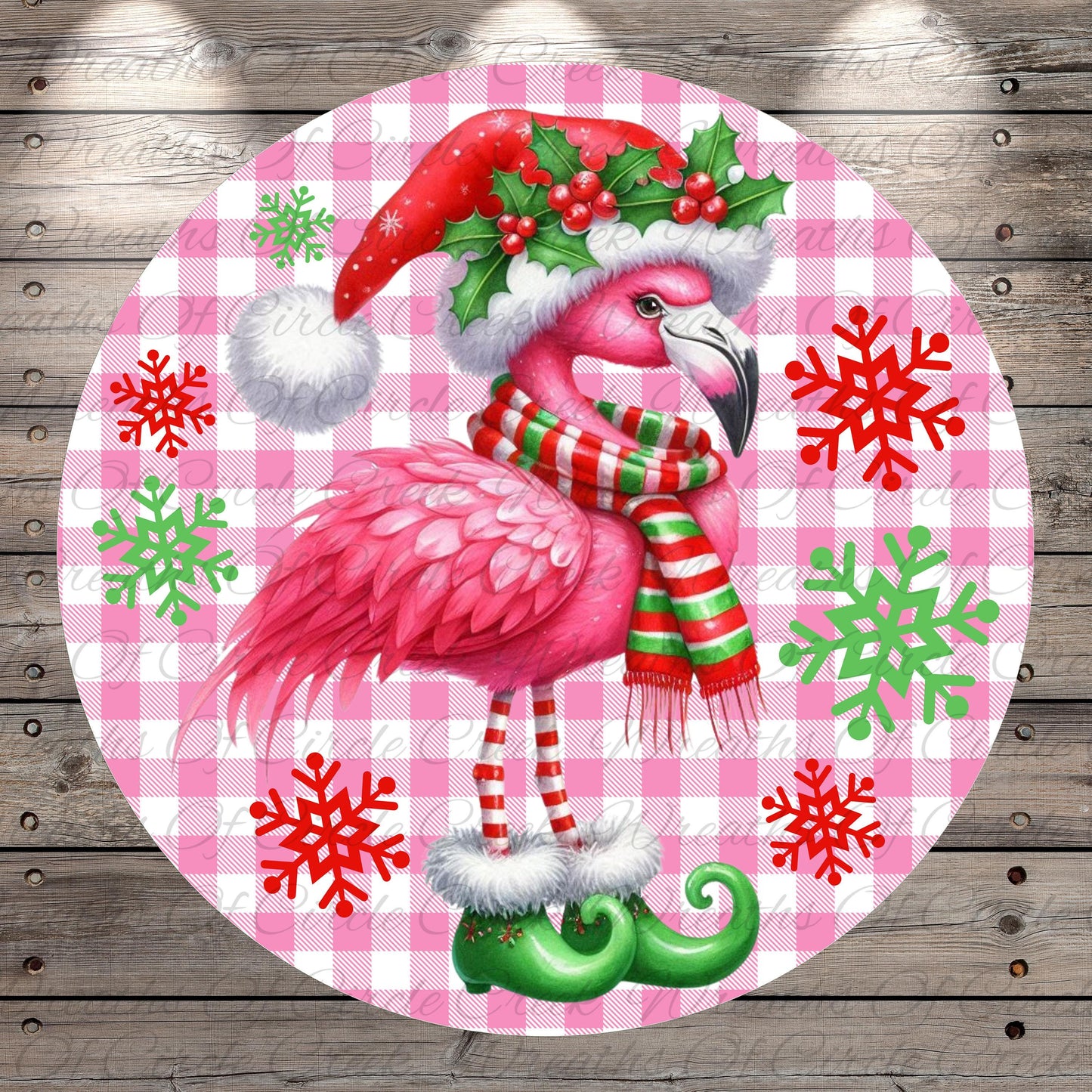 A pink flamingo wearing a Santa hat and scarf, with snowflakes and green elf boots, is the central focus of the image.
