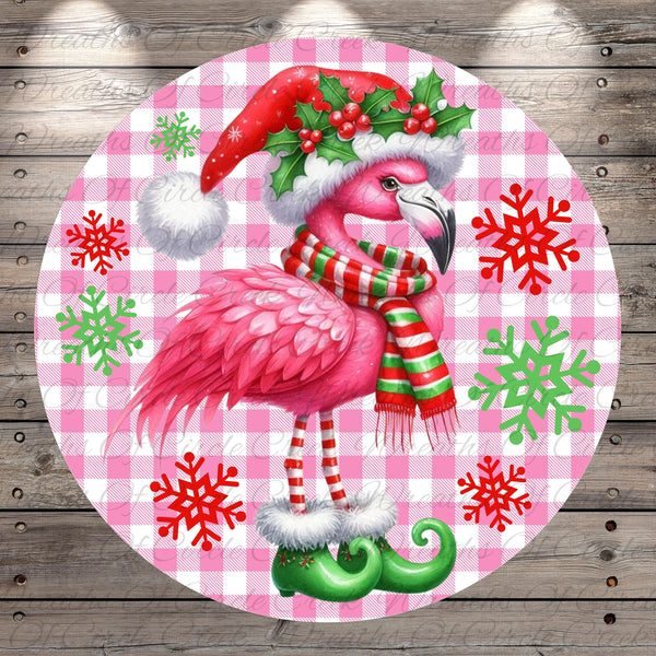 A pink flamingo wearing a Santa hat and scarf, with snowflakes and green elf boots, is the central focus of the image.