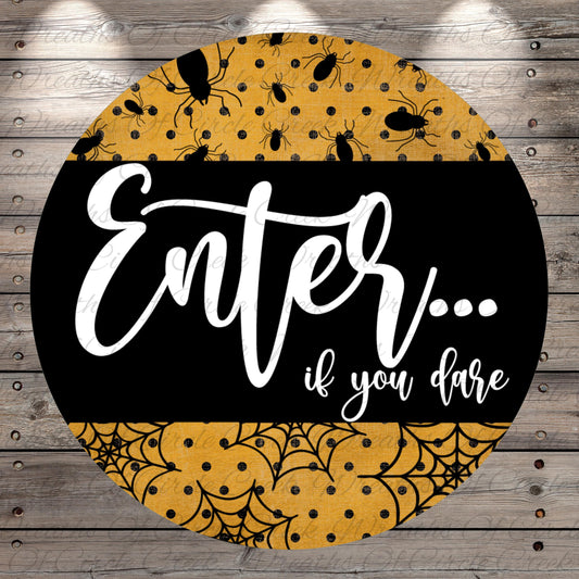 a circular sign with a black background and a yellow and black patterned design. The sign has the text "Enter... if you dare" written in white cursive font.