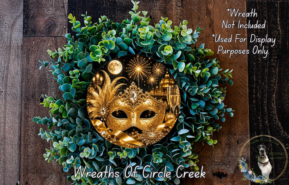 A wreath made of green leaves and a golden mask with a moon and fireworks in the background, placed on a wooden surface.