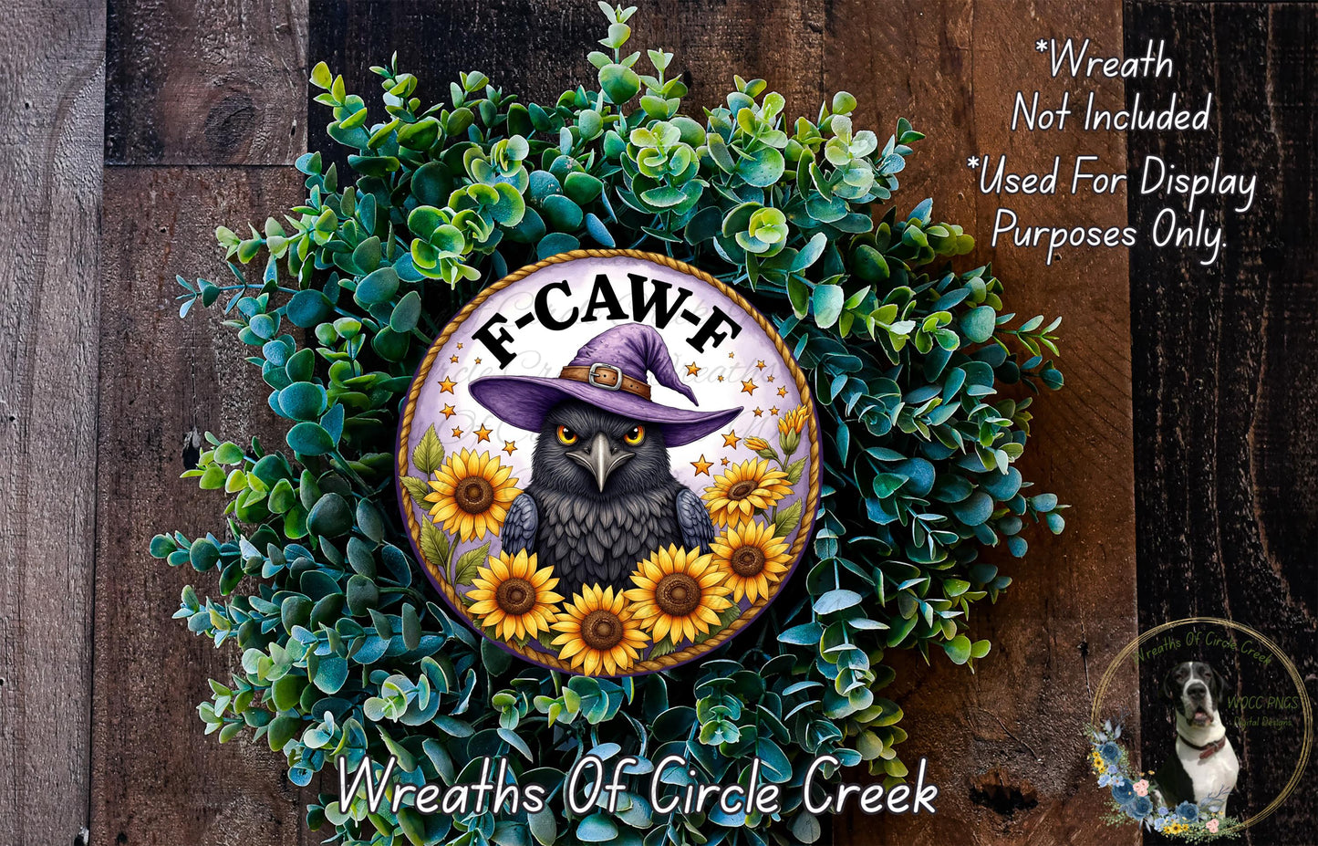 a wreath with a black owl wearing a purple hat and surrounded by sunflowers. The wreath is placed on a wooden surface.