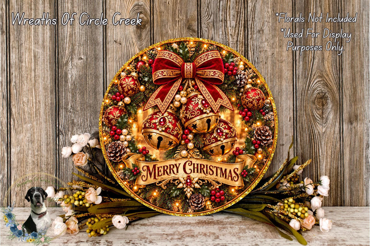 A festive Christmas wreath with a red bow, bells, and a "Merry Christmas" banner, surrounded by pine cones, berries, and flowers, placed on a wooden surface.