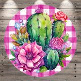 A vibrant and colorful arrangement of cacti and flowers, including a large pink flower, against a pink and white checkered background.